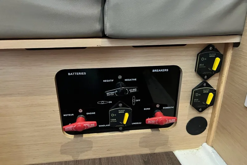 Toofun Yacht Photos Pics Control panel of a 2016 Beneteau Oceanis 38 sailboat, featuring battery switches and breakers.