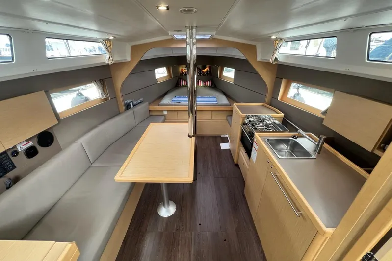 Toofun Yacht Photos Pics Interior of 2016 Beneteau Oceanis 38 yacht, featuring modern kitchen and cozy seating area.