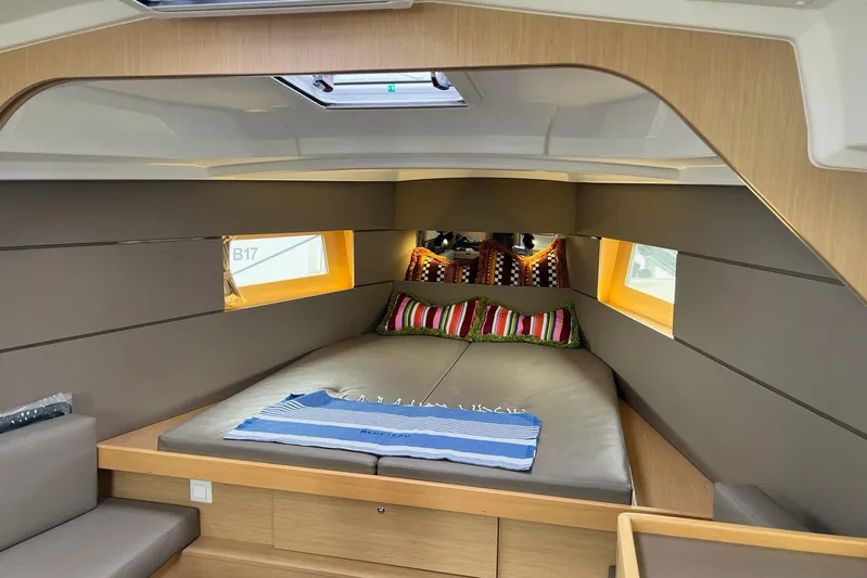 Toofun Yacht Photos Pics Cozy interior cabin of 2016 Beneteau Oceanis 38 sailboat with colorful pillows.