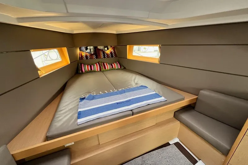 Toofun Yacht Photos Pics Luxurious interior cabin of 2016 Beneteau Oceanis 38 sailboat with cozy bedding.