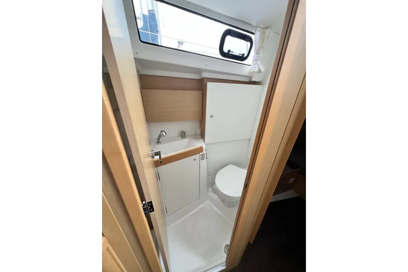 Toofun Yacht Photos Pics 2016 Beneteau Oceanis 38 bathroom interior with sink, toilet, and window.