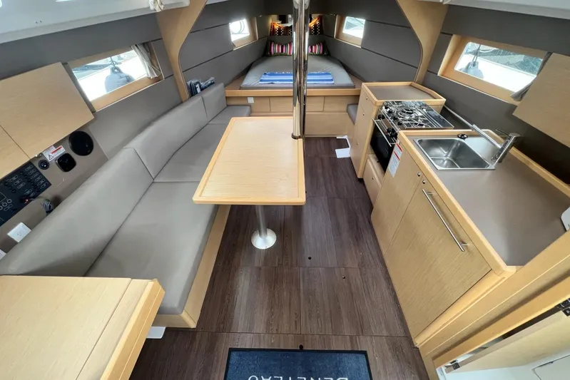 Toofun Yacht Photos Pics Interior of 2016 Beneteau Oceanis 38 sailboat with modern kitchen and seating area.