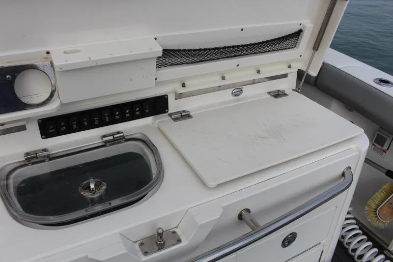  Yacht Photos Pics 2020 Boston Whaler 350 Outrage boat interior with utility station and storage compartments.