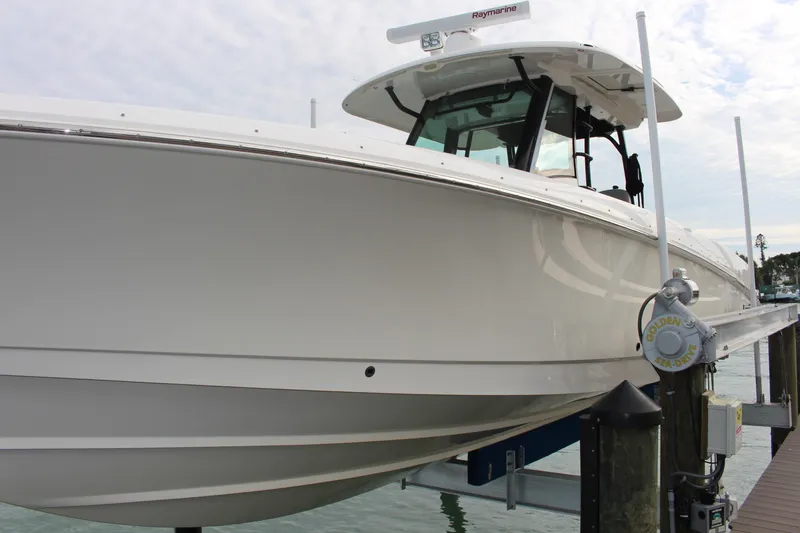  Yacht Photos Pics 2020 Boston Whaler 350 Outrage boat docked, showcasing sleek design and advanced features.