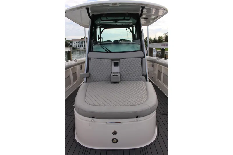  Yacht Photos Pics 2020 Boston Whaler 350 Outrage boat interior with cushioned seating and sleek design.