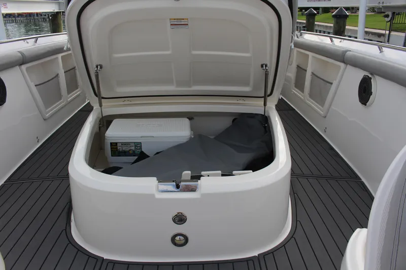  Yacht Photos Pics 2020 Boston Whaler 350 Outrage boat storage compartment with cooler and cover.