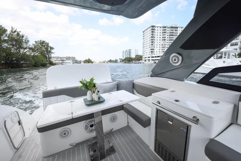  Yacht Photos Pics Luxury Valiatt 350GT yacht interior with modern seating, table, and scenic waterfront view.