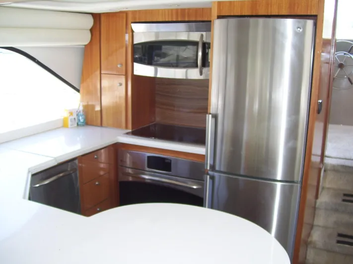  Yacht Photos Pics Modern kitchen in 1999 Bayliner 5788 Pilot House Motoryacht with stainless steel appliances.