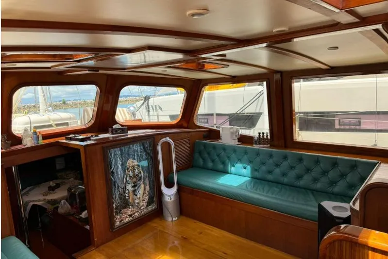  Yacht Photos Pics Luxurious interior of 1987 Don Brooke 77 yacht with teal seating and wood accents.