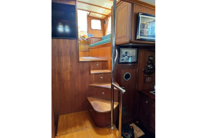  Yacht Photos Pics Interior of 1987 Don Brooke 77 yacht with wooden stairs and nautical decor.