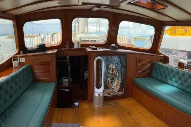  Yacht Photos Pics Interior of 1987 Don Brooke 77 yacht with green seating and tiger artwork.