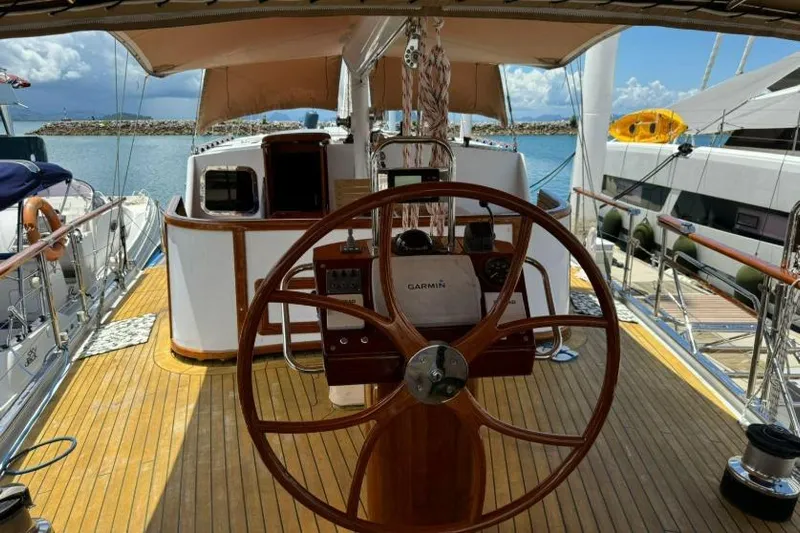  Yacht Photos Pics Wooden deck and steering wheel of 1987 Don Brooke 77 yacht, docked at marina.