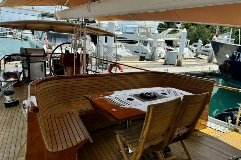  Yacht Photos Pics Luxurious 1987 Don Brooke 77 yacht with elegant wooden deck and marina view.