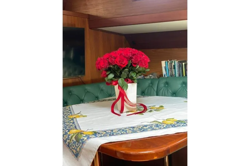  Yacht Photos Pics Red roses in a vase on a table inside a 1987 Don Brooke 77 yacht.