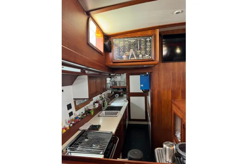  Yacht Photos Pics 1987 Don Brooke 77 yacht kitchen with wooden cabinetry and modern appliances.