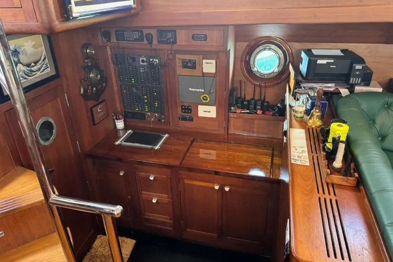  Yacht Photos Pics Control panel and navigation area inside a 1987 Don Brooke 77 yacht, featuring wood finish and equipment.