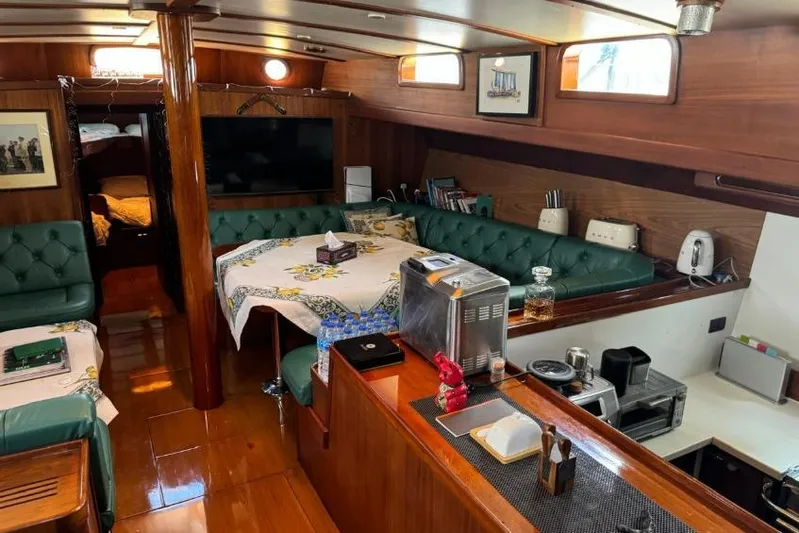  Yacht Photos Pics Luxurious 1987 Don Brooke 77 yacht interior with elegant wood finishes and cozy seating area.