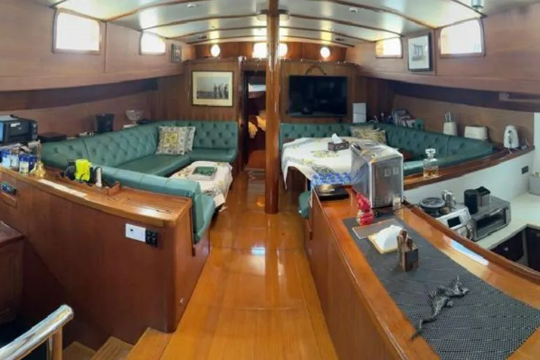  Yacht Photos Pics Luxurious interior of 1987 Don Brooke 77 yacht with elegant wood finish and cozy seating.