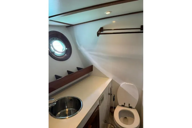  Yacht Photos Pics Compact yacht bathroom with porthole, sink, and toilet in a 1987 Don Brooke 77 model.