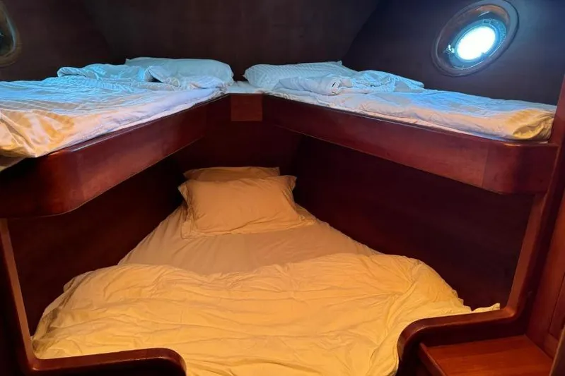  Yacht Photos Pics Cozy wooden cabin with bunk beds and porthole, Don Brooke 77, 1987.