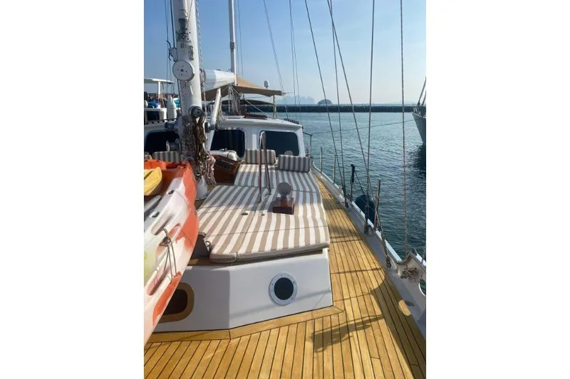  Yacht Photos Pics Sailing yacht deck with striped cushions, Don Brooke 77, 1987 model, docked in sunny marina.