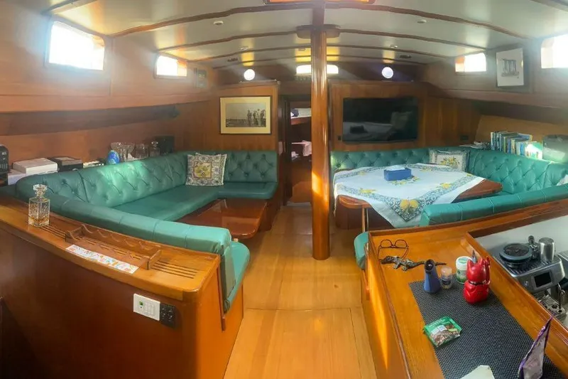  Yacht Photos Pics Luxurious 1987 Don Brooke 77 yacht interior with teal seating and wooden finishes.