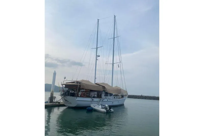  Yacht Photos Pics Sailing yacht Don Brooke 77, 1987 model, docked at marina with calm waters.
