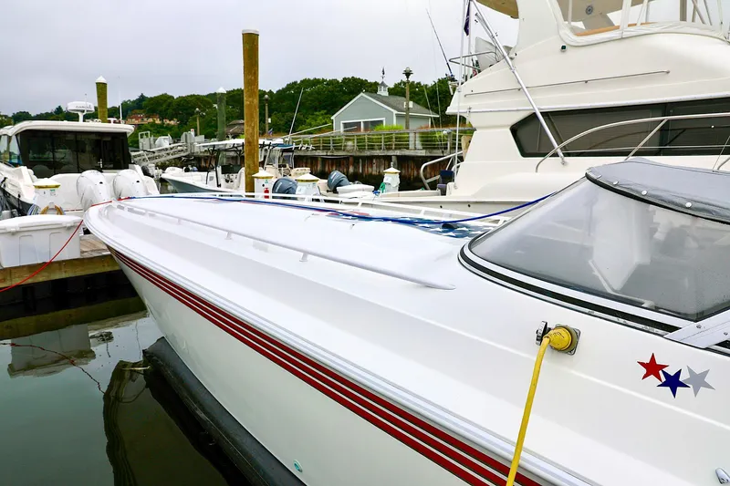  Yacht Photos Pics 2001 Fountain Lightning 42 speedboat docked in marina, featuring sleek design and red accents.