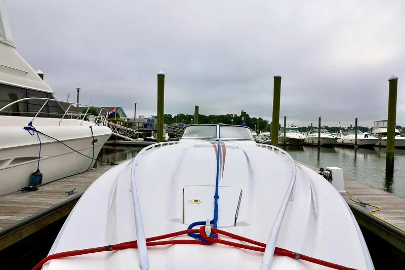  Yacht Photos Pics 2001 Fountain Lightning 42 speedboat docked at marina, overcast sky.