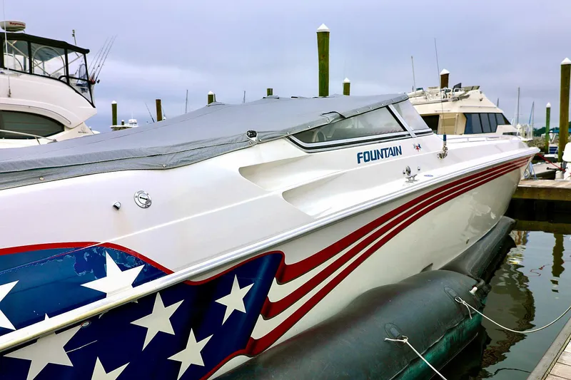  Yacht Photos Pics 2001 Fountain Lightning 42 boat with American flag design docked at marina.
