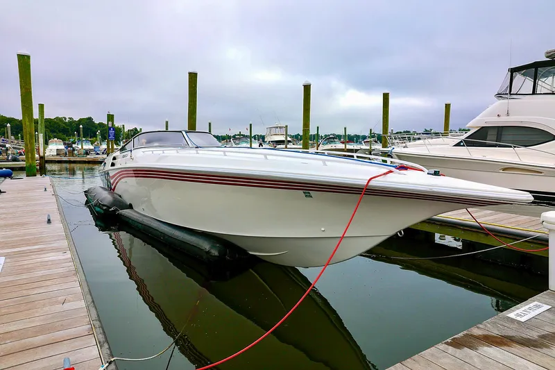  Yacht Photos Pics 2001 Fountain Lightning 42 speedboat docked at marina, overcast sky.