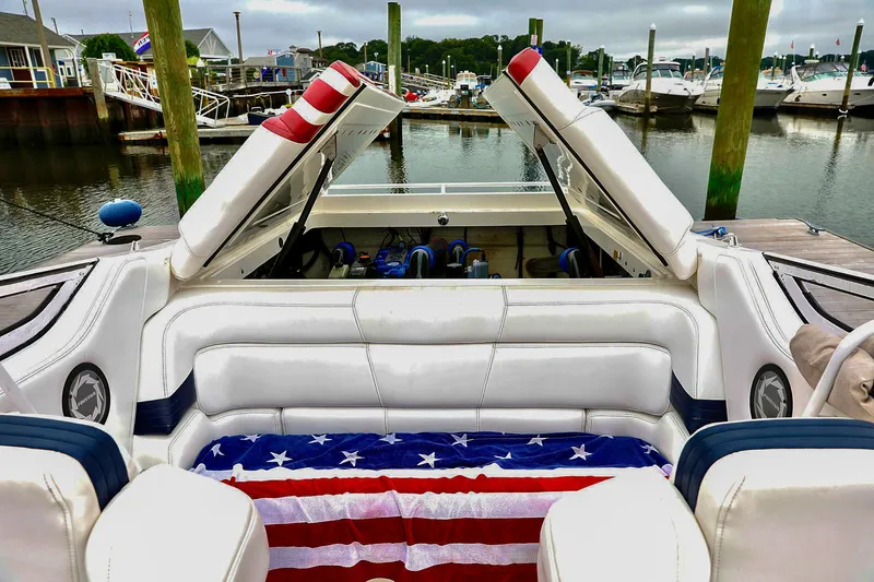  Yacht Photos Pics 2001 Fountain Lightning 42 boat with American flag upholstery at a marina.