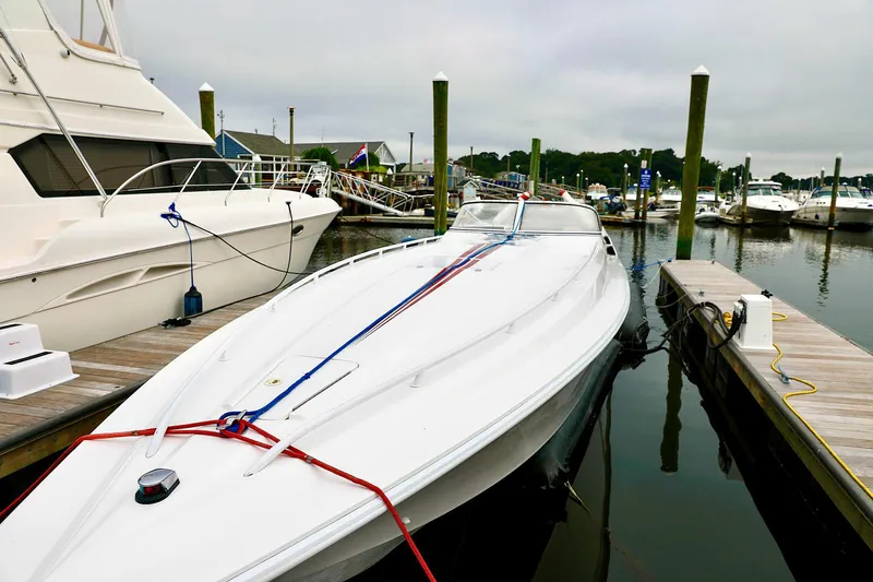  Yacht Photos Pics 2001 Fountain Lightning 42 speedboat docked at marina, overcast sky.