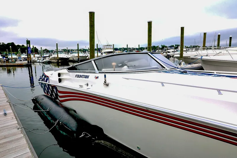  Yacht Photos Pics Fountain Lightning 42 boat, 2001 model, docked with American flag design.