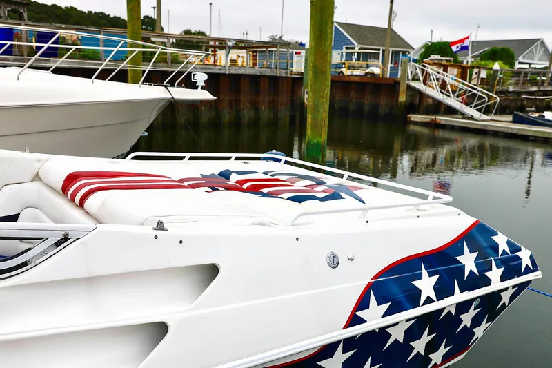  Yacht Photos Pics 2001 Fountain Lightning 42 boat with American flag design docked at marina.