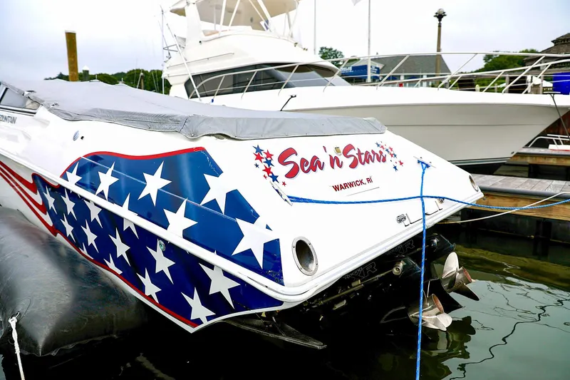  Yacht Photos Pics Fountain Lightning 42 boat, 2001 model, with star-spangled design docked in marina.