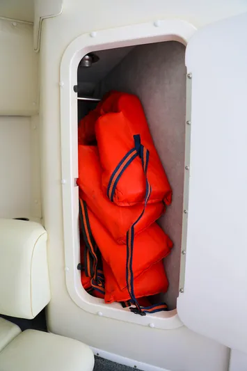 Yacht Photos Pics Orange life jackets stored in a compartment on a 2001 Fountain Lightning 42 boat.