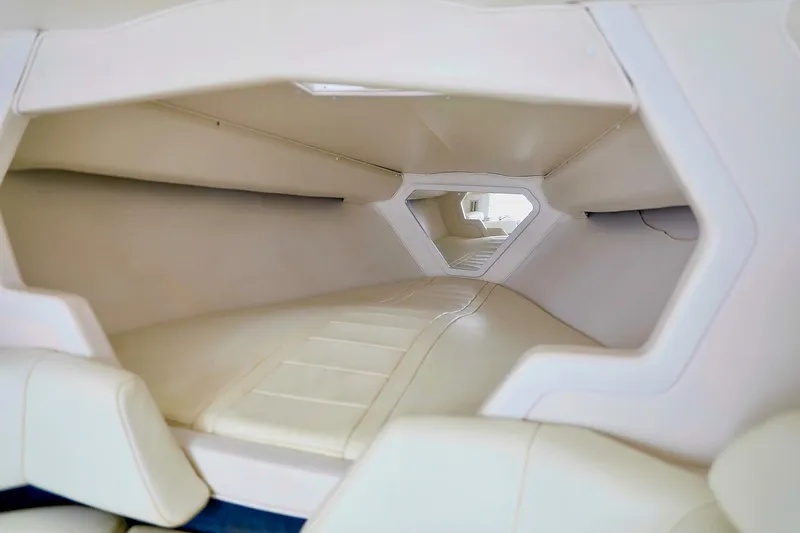  Yacht Photos Pics Interior cabin of 2001 Fountain Lightning 42 boat, featuring sleek white upholstery.