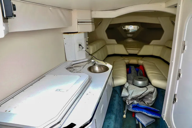  Yacht Photos Pics Interior of 2001 Fountain Lightning 42 boat with kitchenette and seating area.