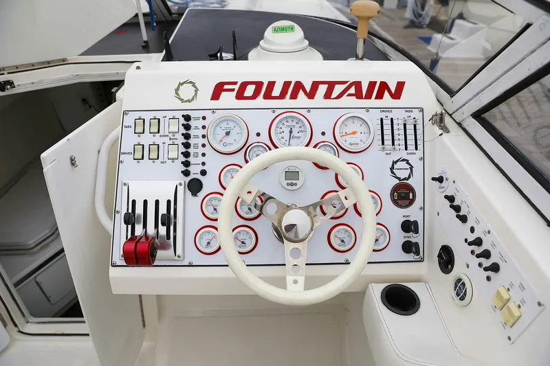  Yacht Photos Pics Control panel of 2001 Fountain Lightning 42 speedboat with gauges and steering wheel.