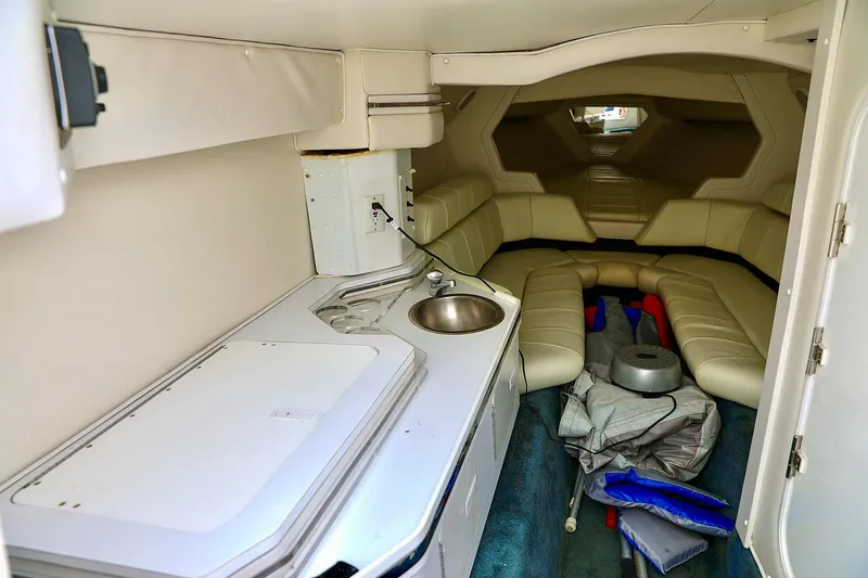  Yacht Photos Pics Interior of 2001 Fountain Lightning 42 boat with kitchenette and seating area.