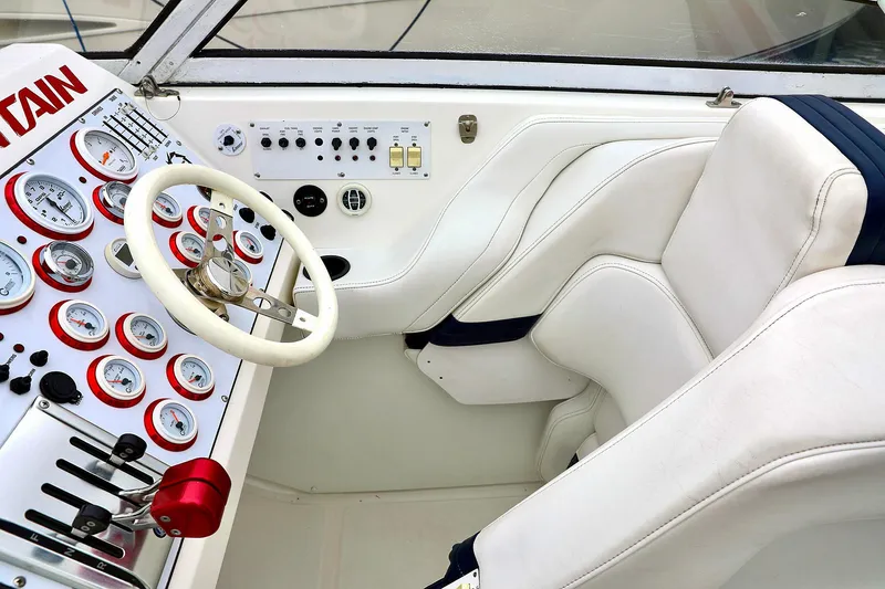  Yacht Photos Pics Interior of a 2001 Fountain Lightning 42 boat with white leather seats and control panel.