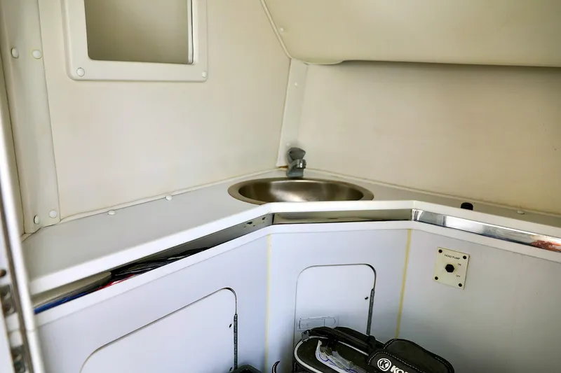  Yacht Photos Pics 2001 Fountain Lightning 42 boat interior with compact sink and storage area.