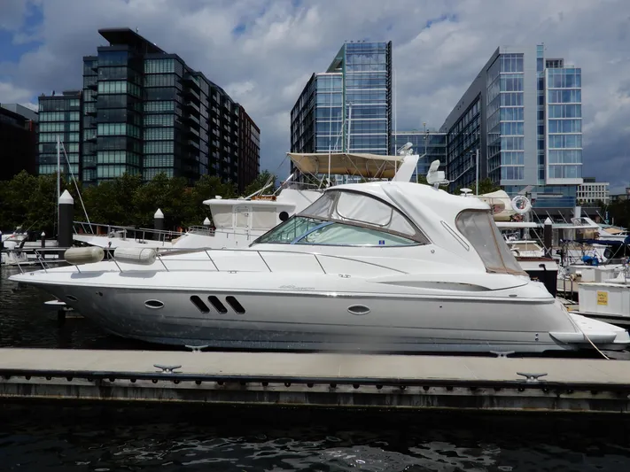  Yacht Photos Pics 2008 Cruisers Yachts 460 Express docked in urban marina with modern buildings.