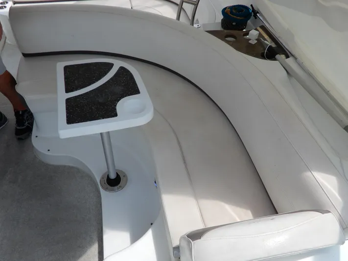  Yacht Photos Pics 2008 Cruisers Yachts 460 Express interior with curved seating and small table.