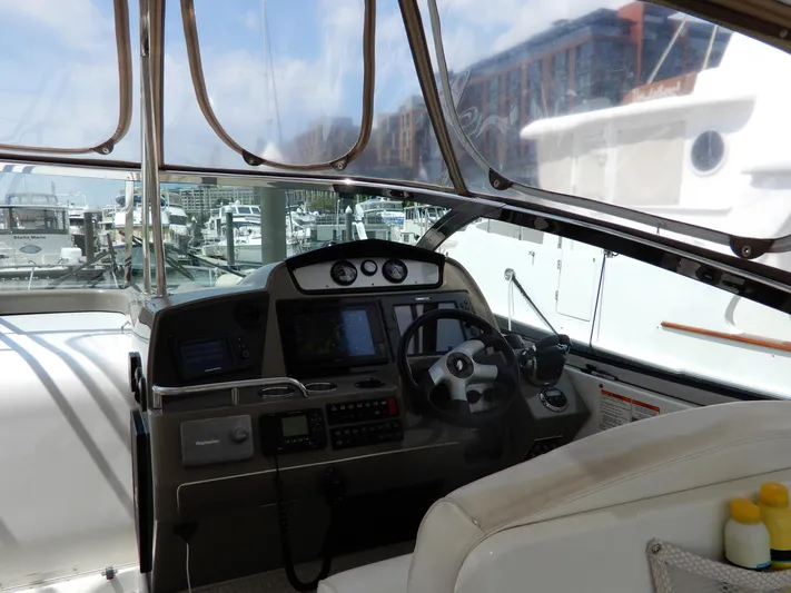  Yacht Photos Pics Helm of 2008 Cruisers Yachts 460 Express with navigation equipment and marina view.