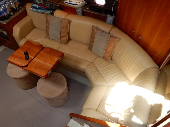  Yacht Photos Pics Luxurious interior of 2008 Cruisers Yachts 460 Express with beige leather seating and wooden table.