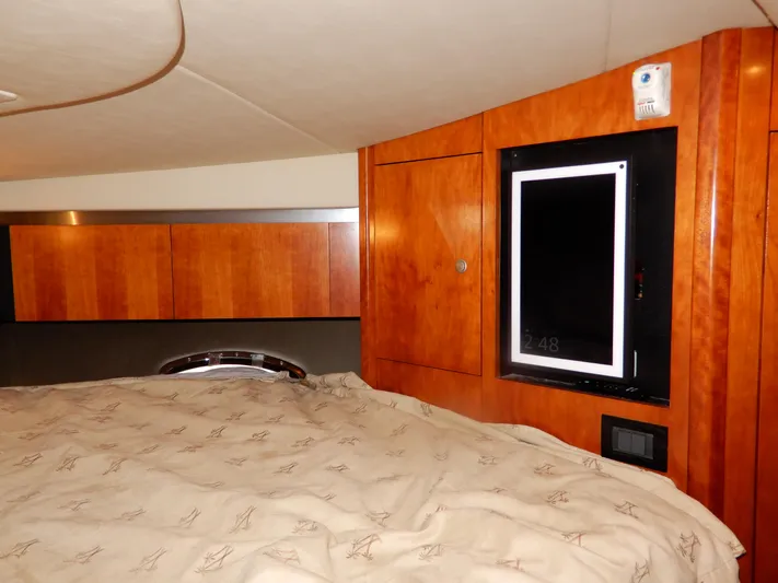  Yacht Photos Pics 2008 Cruisers Yachts 460 Express cabin interior with wood paneling and bed.