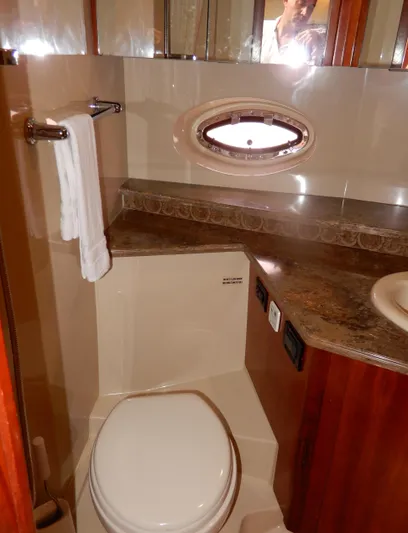  Yacht Photos Pics Luxurious bathroom in 2008 Cruisers Yachts 460 Express with elegant fixtures and porthole window.