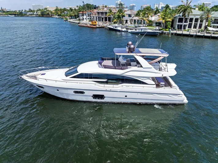 Blue Abalone Yacht Photos Pics Luxurious 2015 Ferretti Yachts 690 cruising on serene waters near waterfront homes.